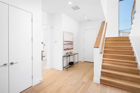 Stairs featuring hardwood / wood-style flooring