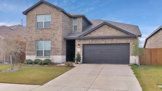 View of front of house with a garage and a front lawn