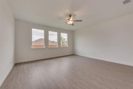 Spare room with light hardwood / wood-style flooring and ceiling fan