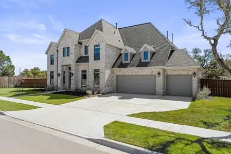 French provincial home with a garage, a shingled roof, fence, a front lawn, and brick siding