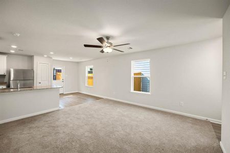 Living room is open and flows directly to the kitchen.