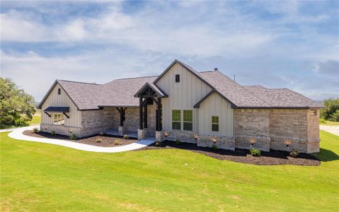 Modern farmhouse style home with a front lawn