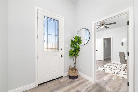 Foyer with light hardwood / wood-style flooring and ceiling fan