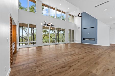 Great Room shares a see-tru fireplace with the foyer. Both rooms have 20'ceilings. Notice how the oak sentinels become a part of the interior landscape.