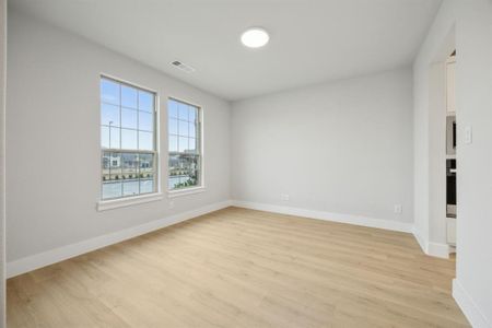 Unfurnished room featuring light hardwood / wood-style flooring and a water view