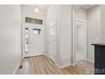 Entry way has coat closet and luxury vinyl plank flooring throughout main floor (except for bedrooms)