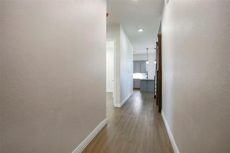 Hall featuring light hardwood / wood-style floors.