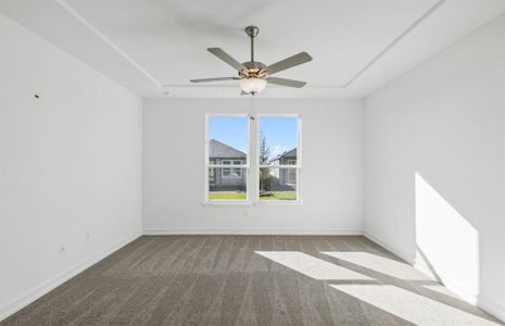 Elegant owner's suite with tray ceiling *real home pictured