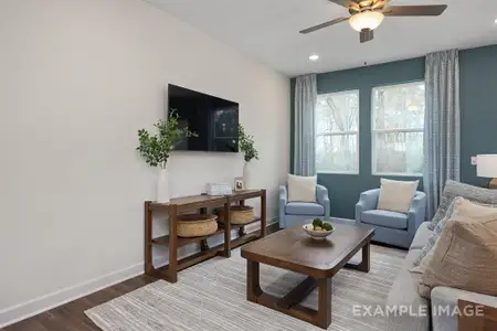 Living room with ceiling fan and hardwood / wood-style flooring