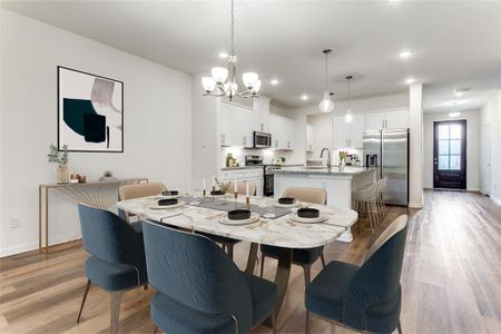 Virtually stage - Dining space featuring sink, light hardwood / wood-style flooring, and a chandelier