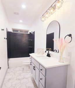 Beautiful bathroom featuring vanity, shower / washtub combination