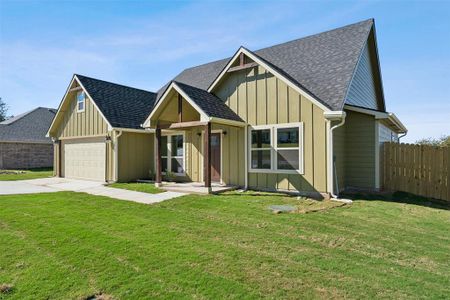 View of front of home featuring a front yard and a garage