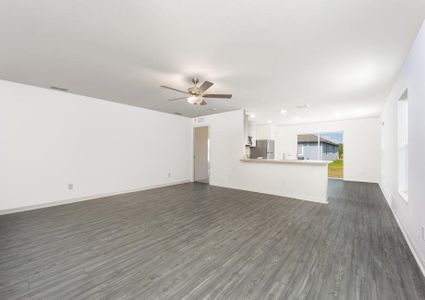 A large family room with an adjoining kitchen