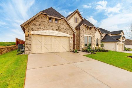 View of front of home with a garage and a front yard