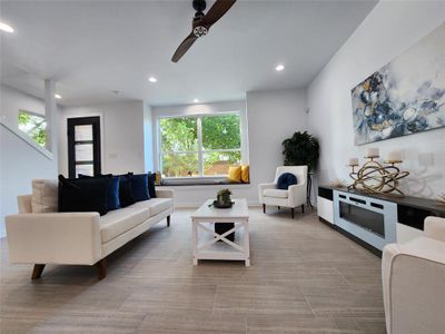 Living room featuring plenty of natural light and ceiling fan