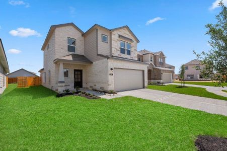 This side view highlights the meticulous attention to detail in the brick and stone exterior, landscaped yard, and cedar privacy fence. A perfect setup for a peaceful suburban retreat with style.