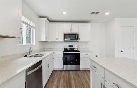 Upgraded kitchen with ample cabinet space *real home pictured