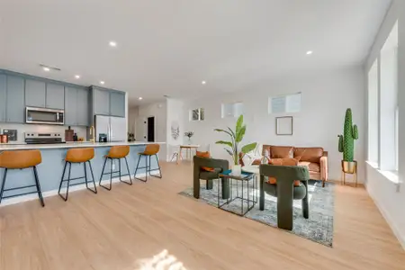 Living room featuring sink and light hardwood / wood-style flooring