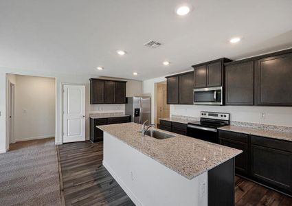 Enjoy stunning granite countertops and designer wood cabinetry in this kitchen.