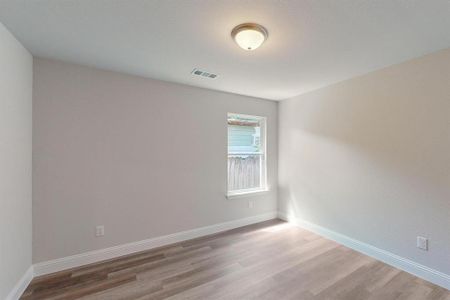 Unfurnished room with hardwood / wood-style flooring