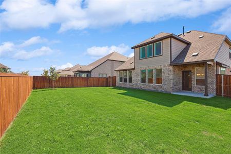 Rear view of house with a lawn and a patio area