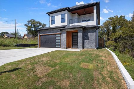 Modern home with ceiling fan, a balcony, a garage, and a front lawn