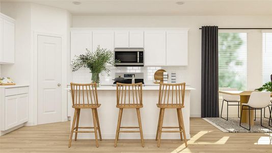 Kitchen featuring stainless steel appliances, white cabinets, decorative backsplash, light wood-type flooring, and a kitchen breakfast bar