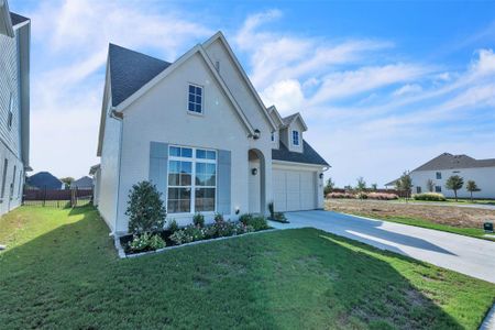 Front facade featuring a front yard and a garage