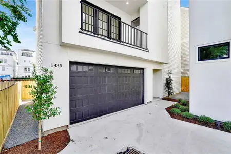 Driveway leading to the  two-car attached garage.