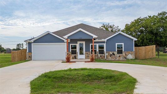 View of front of house featuring a garage and a front lawn