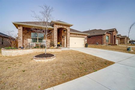 View of front of home with brick siding, a porch, concrete driveway, an attached garage, and a front lawn