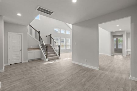 Another perspective of the dining room looking through to the family room. Sample photo of completed home with similar floor plan. As-built interior colors and selections may vary.