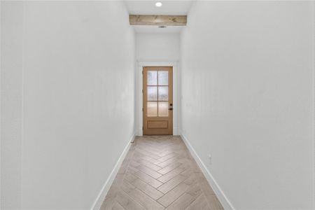 Entryway featuring beam ceiling