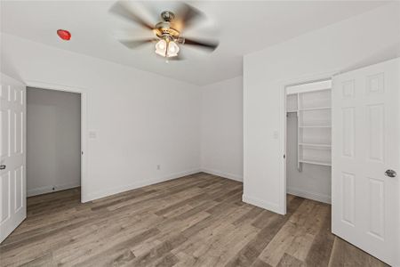 Unfurnished bedroom featuring a closet, ceiling fan, and hardwood / wood-style floors