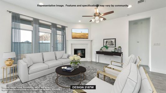 Living room with a brick fireplace, dark hardwood / wood-style flooring, and ceiling fan