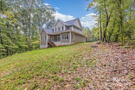 Rear view of home showing the many windows covered back porch