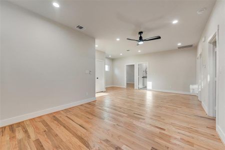 Unfurnished room featuring light wood-type flooring and ceiling fan