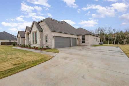 View of home's exterior featuring a yard and a garage