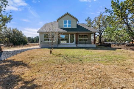 Rear view of house featuring a yard