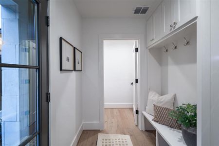 Mudroom with light hardwood / wood-style floors