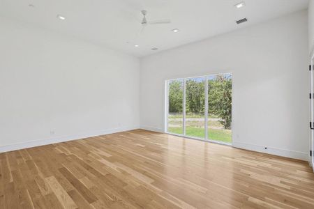 Spare room with ceiling fan and light hardwood / wood-style floors