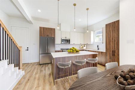 Virtually staged dining area and kitchen on the first floor