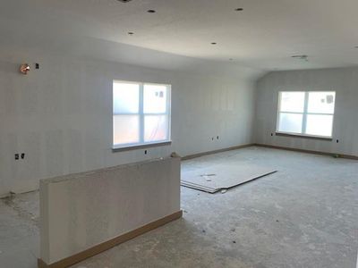 Unfurnished room with vaulted ceiling