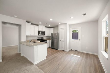 Stainless-Steel appliances with white cabinets.