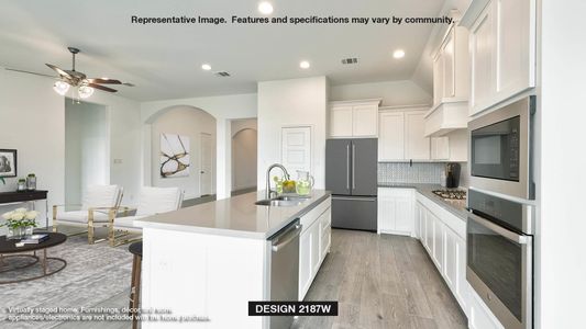 Kitchen with an island with sink, appliances with stainless steel finishes, backsplash, white cabinets, and sink