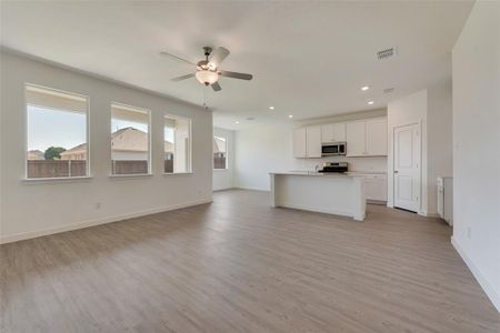 Unfurnished living room featuring light hardwood / wood-style flooring and ceiling fan