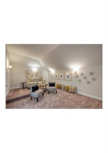 Carpeted living room with lofted ceiling