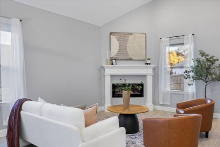 Living room featuring light hardwood / wood-style floors and vaulted ceiling