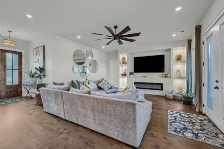 Living room featuring hardwood / wood-style floors and ceiling fan