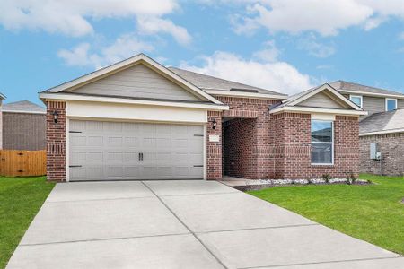 Ranch-style house featuring a front lawn and a garage